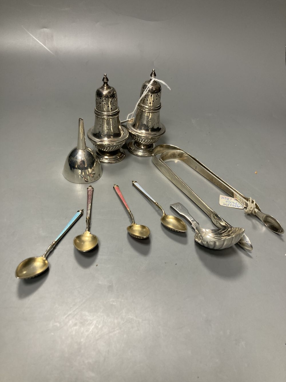 A pair of late Victorian silver pepperettes, London, 1891, 95mm, A George III silver caddy spoon, etc.